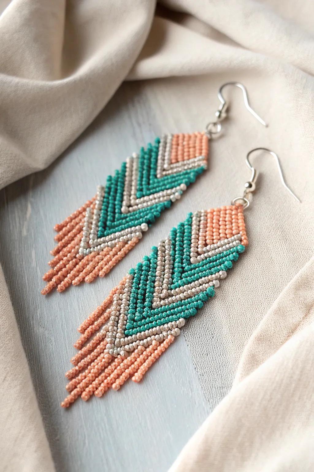 Elevate your style with these stunning teal and peach chevron earrings, a perfect blend of bold colors and minimalist elegance.